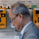 A man passes a bitcoin ATM in Hong Kong on December 21st, 2017. Photo: AP